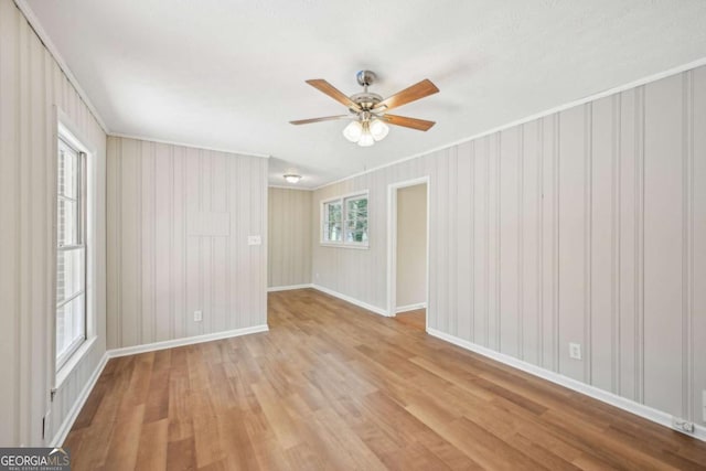 unfurnished room with ornamental molding, light hardwood / wood-style floors, and ceiling fan