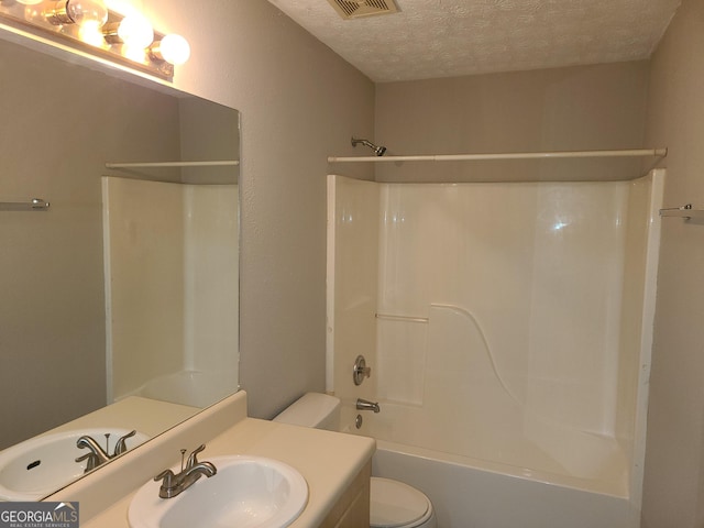 full bathroom with shower / bathing tub combination, vanity, toilet, and a textured ceiling