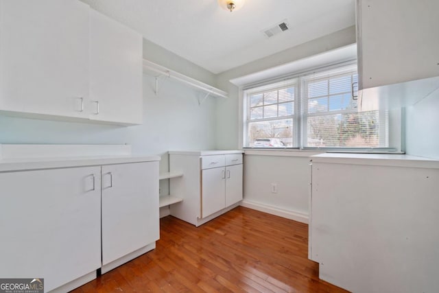 laundry room with light hardwood / wood-style flooring