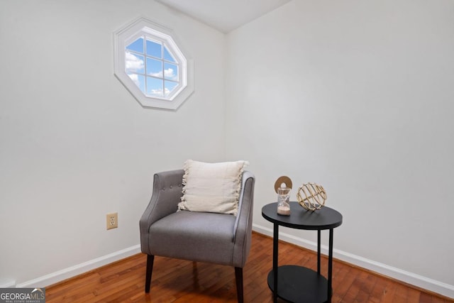 living area with hardwood / wood-style flooring