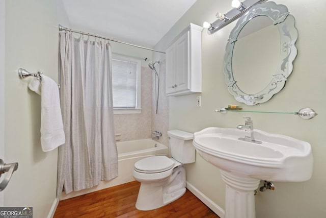 bathroom with wood-type flooring, shower / tub combo with curtain, and toilet