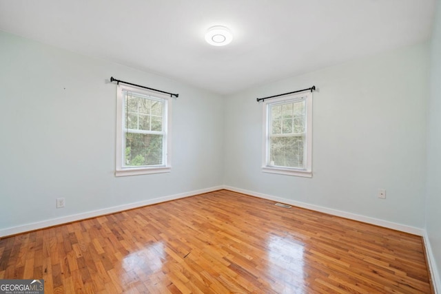 spare room with light hardwood / wood-style flooring