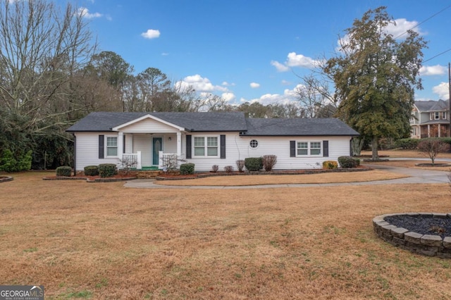 single story home featuring covered porch and a front lawn