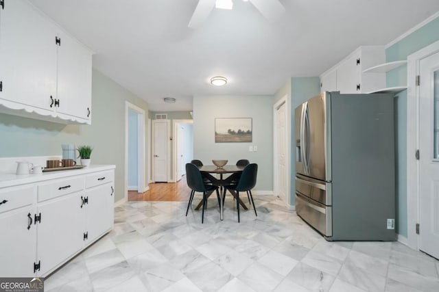 kitchen with white cabinets, ceiling fan, and stainless steel fridge with ice dispenser