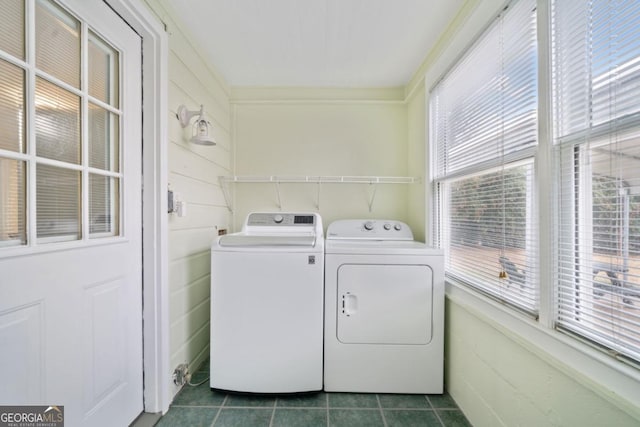 washroom featuring dark tile patterned flooring and washing machine and dryer