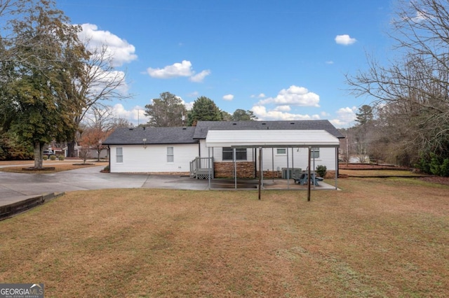 back of house featuring a patio and a yard