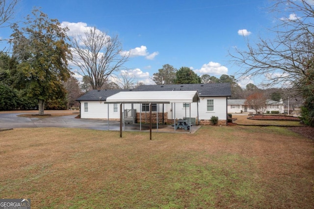 back of property with a patio and a lawn