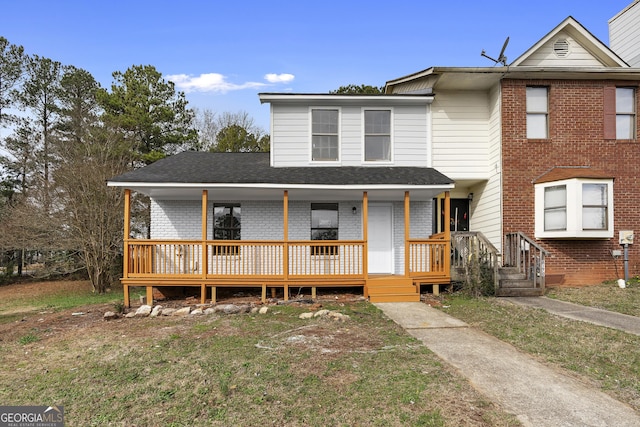 view of front facade with covered porch and a front lawn