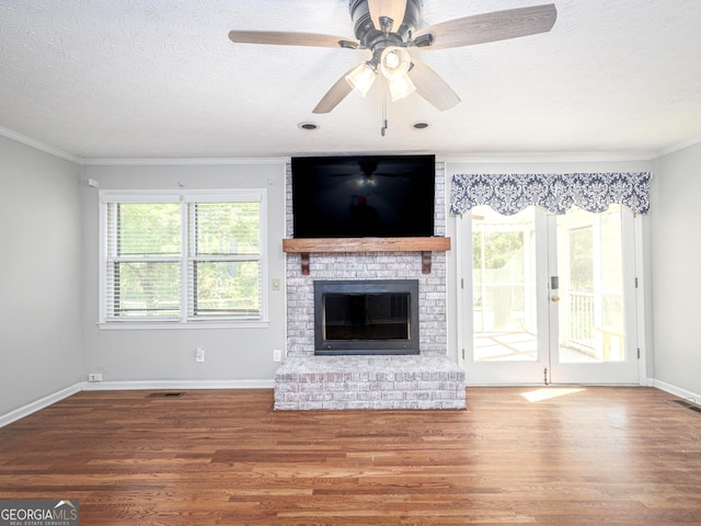 unfurnished living room featuring hardwood / wood-style floors, crown molding, and a textured ceiling