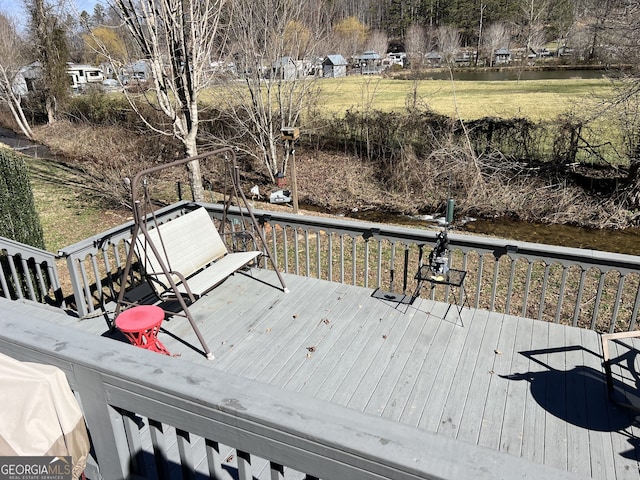 wooden terrace featuring a water view