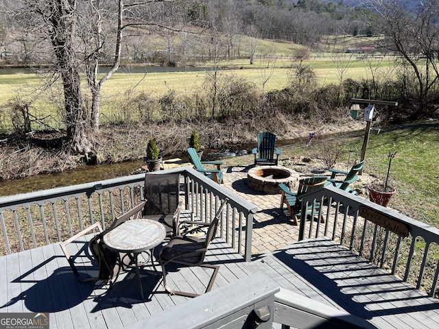 wooden deck featuring a fire pit
