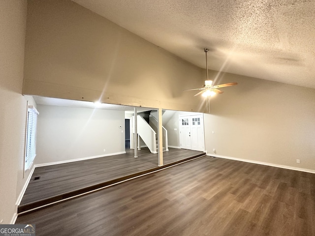 additional living space featuring ceiling fan, dark wood-type flooring, high vaulted ceiling, and a textured ceiling