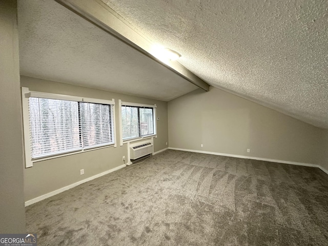 additional living space featuring vaulted ceiling with beams, a wall mounted air conditioner, a textured ceiling, and carpet flooring