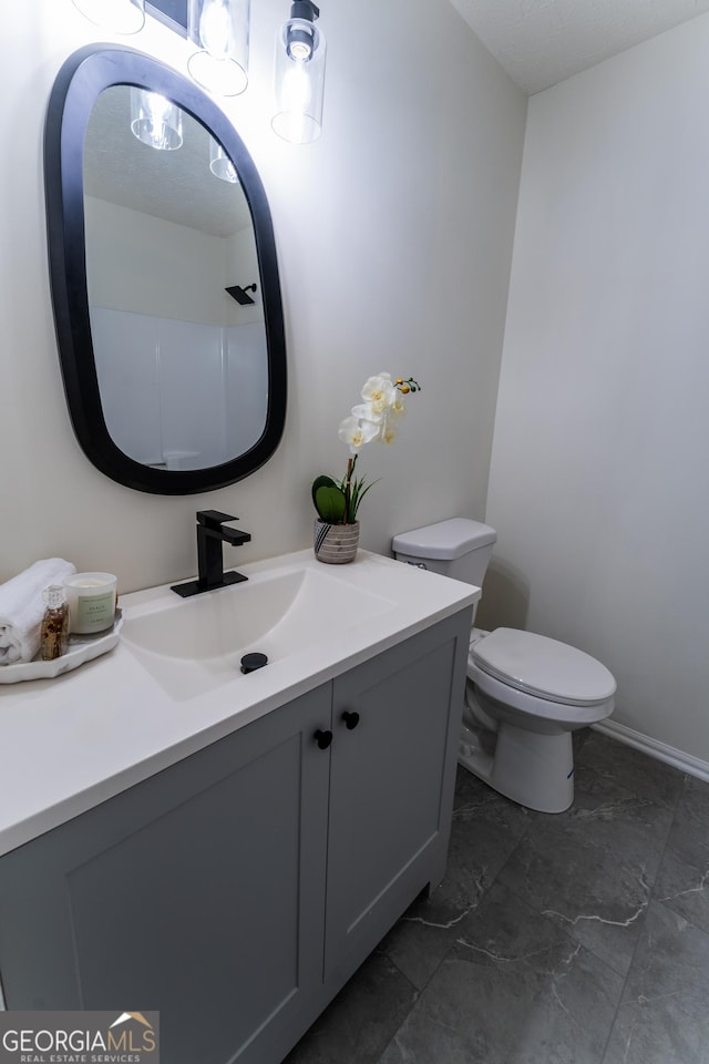 bathroom with toilet and vanity