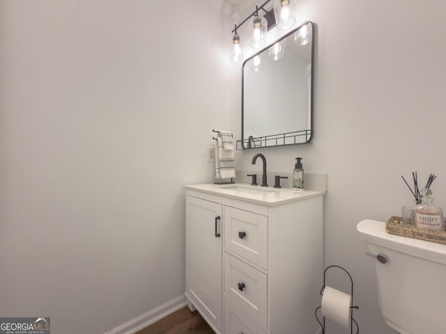 bathroom featuring vanity and toilet