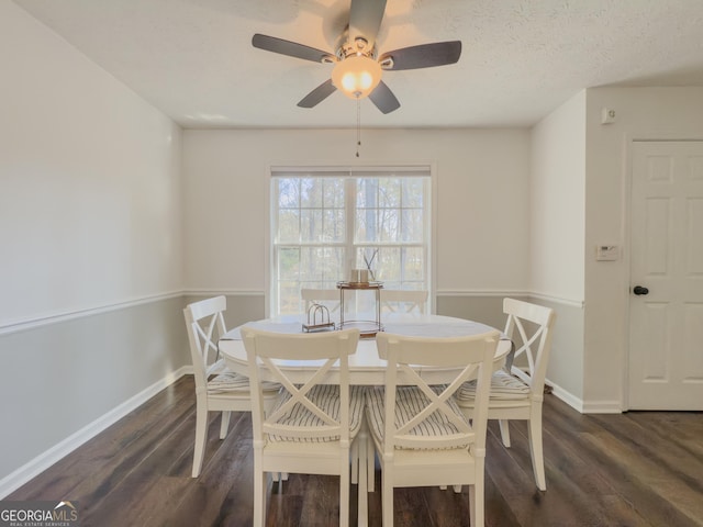 dining room with dark hardwood / wood-style flooring, ceiling fan, and a textured ceiling