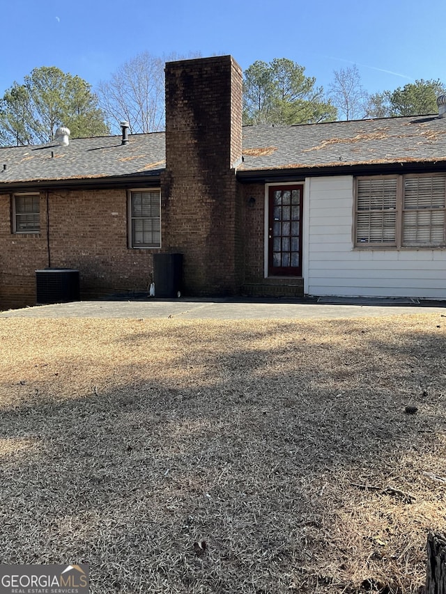 rear view of property featuring central air condition unit