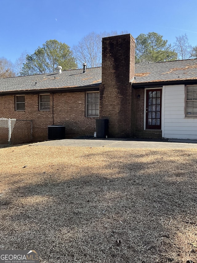 rear view of property featuring central AC