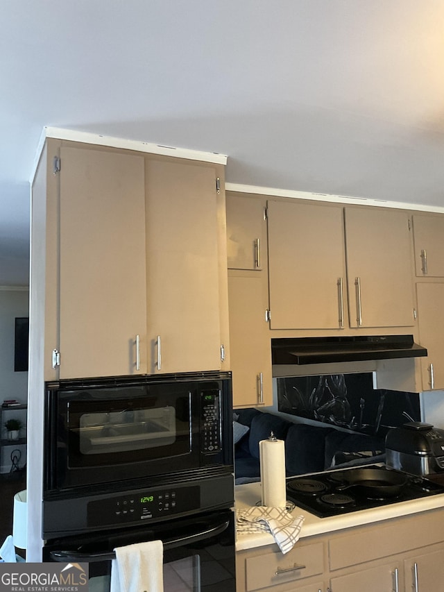 kitchen with tasteful backsplash and black appliances