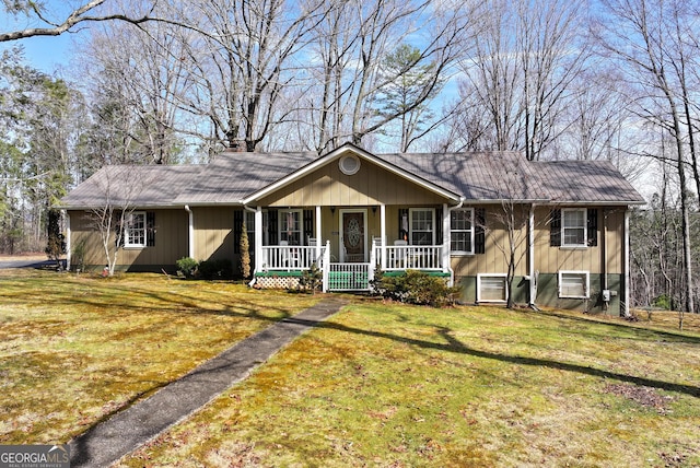 single story home with a porch and a front lawn