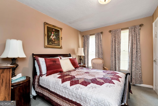 carpeted bedroom featuring a textured ceiling