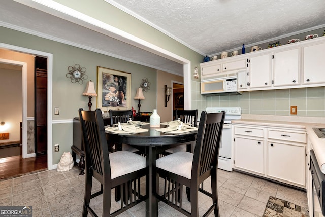 dining space featuring crown molding and a textured ceiling