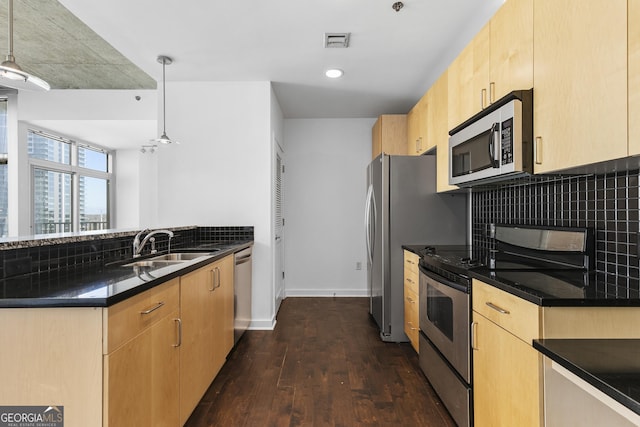 kitchen featuring dark hardwood / wood-style flooring, sink, appliances with stainless steel finishes, decorative backsplash, and pendant lighting