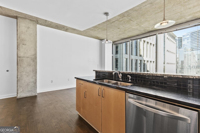 kitchen featuring tasteful backsplash, stainless steel dishwasher, pendant lighting, sink, and dark hardwood / wood-style floors