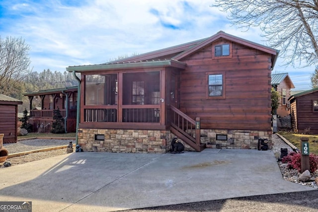 rear view of property with a sunroom