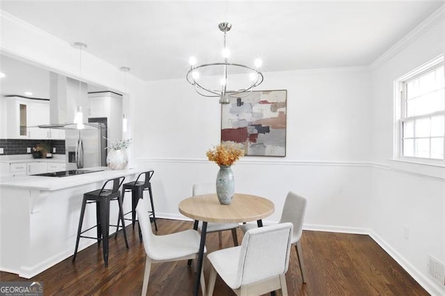 dining area with an inviting chandelier, crown molding, baseboards, and dark wood-style flooring