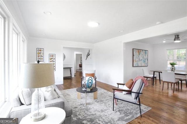 living room featuring recessed lighting, dark wood-style flooring, and baseboards