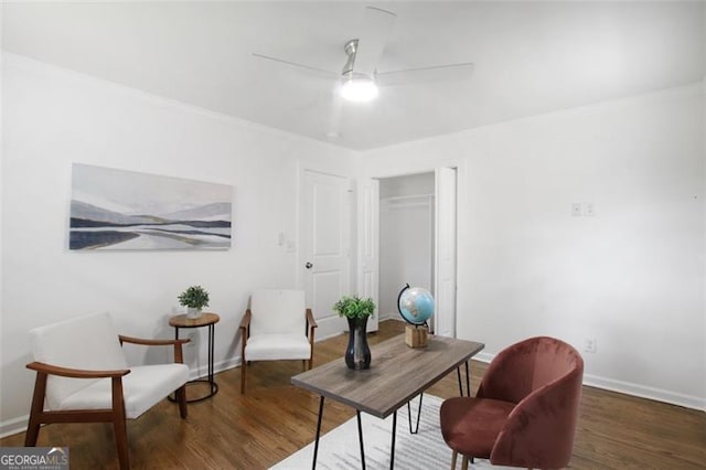 office area featuring dark wood-style flooring, a ceiling fan, and baseboards