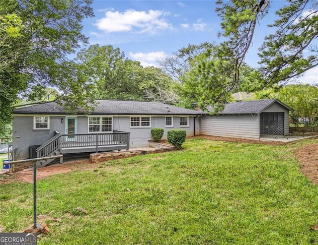 back of property featuring a lawn and a deck