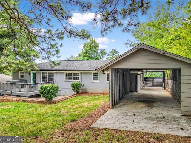 ranch-style house featuring a carport, a front yard, and driveway