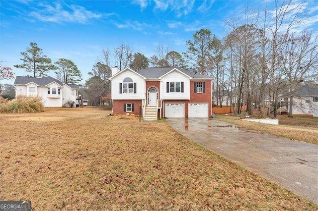 bi-level home featuring a garage and a front lawn