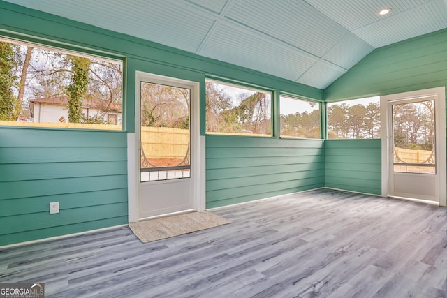 unfurnished sunroom featuring lofted ceiling