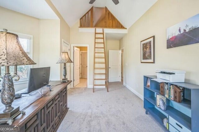 interior space with ceiling fan, high vaulted ceiling, and light carpet