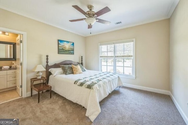 bedroom with light carpet, ceiling fan, crown molding, and connected bathroom