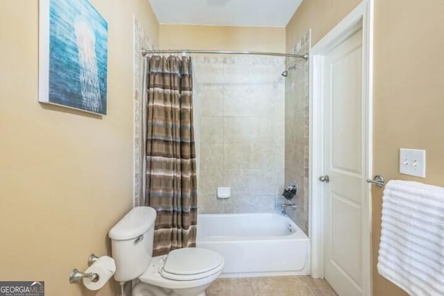 bathroom with tile patterned flooring, toilet, and shower / bath combo with shower curtain