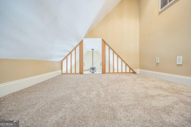 bonus room featuring lofted ceiling, ceiling fan, and carpet flooring