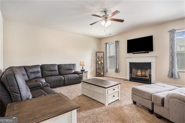 carpeted living room with ceiling fan