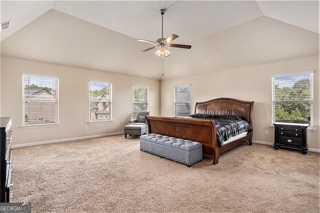 bedroom with multiple windows, vaulted ceiling, and light carpet