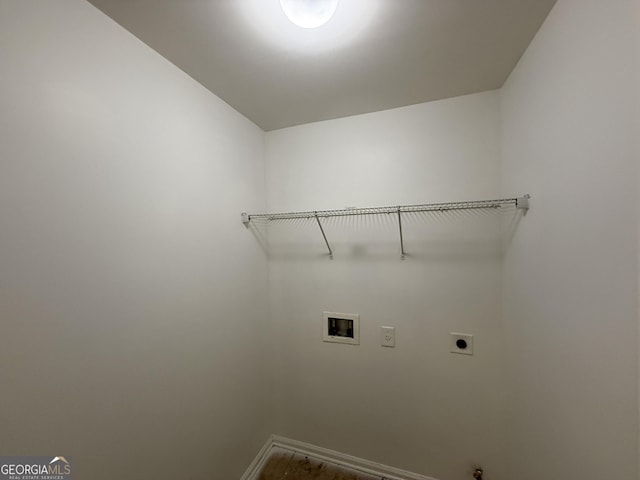 clothes washing area featuring baseboards, laundry area, hookup for a washing machine, and hookup for an electric dryer