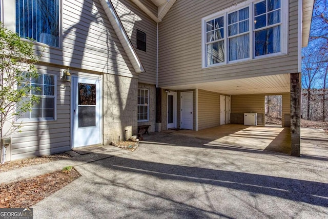 exterior space with a carport and concrete driveway