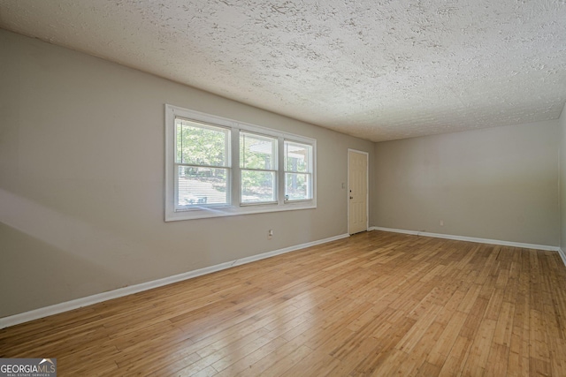 3710 Lynn Dr, Powder Springs, GA 30127 - spare room with light wood-style flooring, a textured ceiling, and baseboards