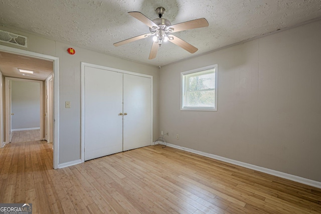 3710 Lynn Dr, Powder Springs, GA 30127 - unfurnished bedroom featuring visible vents, a closet, baseboards, light wood-style flooring, and a textured ceiling