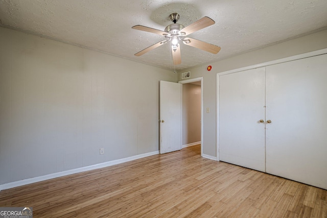 3710 Lynn Dr, Powder Springs, GA 30127 - unfurnished bedroom featuring wood finished floors, a textured ceiling, and a closet