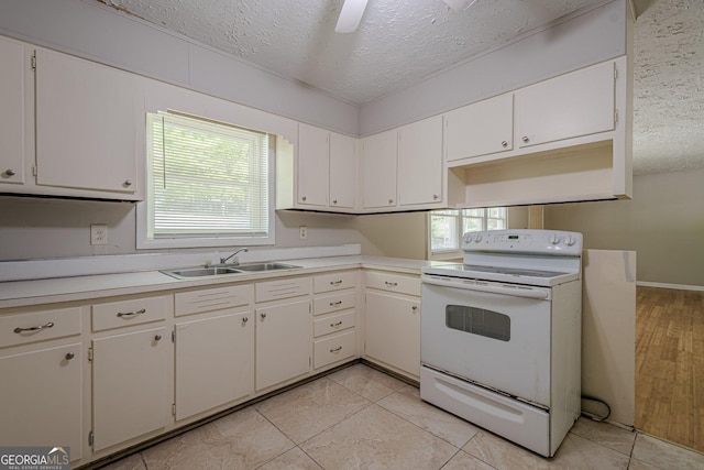 3710 Lynn Dr, Powder Springs, GA 30127 - kitchen featuring light countertops, white electric range oven, a sink, and a textured ceiling