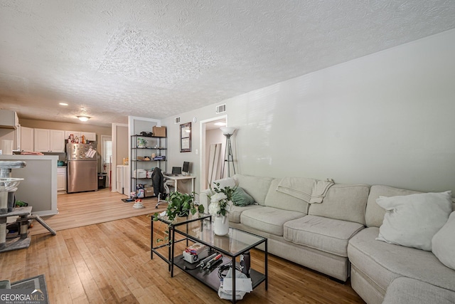 3710 Lynn Dr, Powder Springs, GA 30127 - living area featuring a textured ceiling, visible vents, and light wood-type flooring