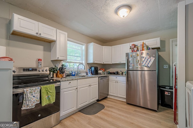 3710 Lynn Dr, Powder Springs, GA 30127 - kitchen featuring white cabinets, light wood-type flooring, stainless steel appliances, and a sink